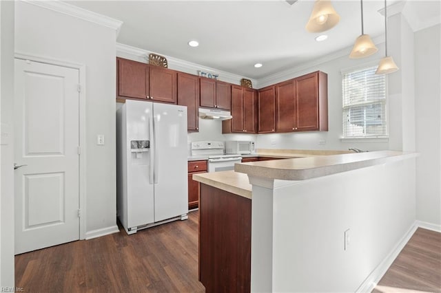 kitchen featuring crown molding, white appliances, hanging light fixtures, dark hardwood / wood-style floors, and kitchen peninsula