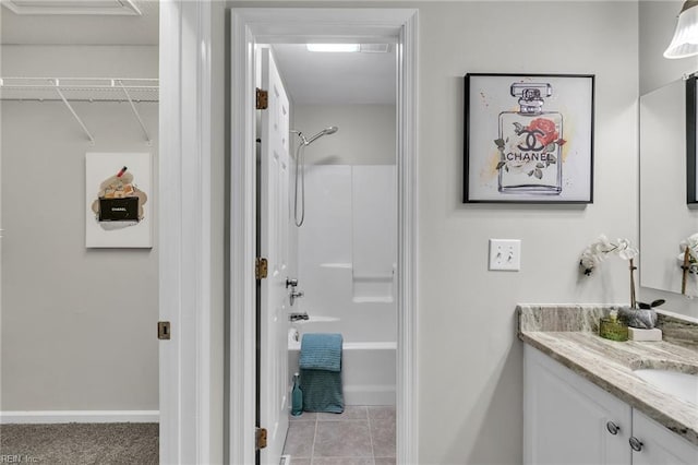 bathroom featuring vanity, tub / shower combination, and tile patterned flooring