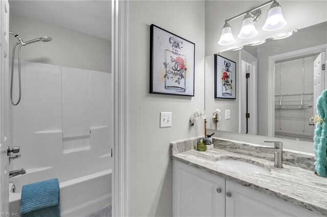 bathroom featuring bathing tub / shower combination and vanity