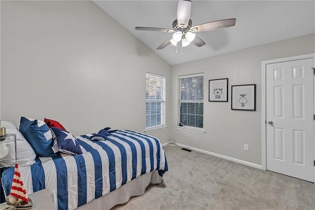 bedroom with vaulted ceiling, light colored carpet, and ceiling fan