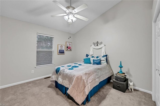 carpeted bedroom with vaulted ceiling and ceiling fan