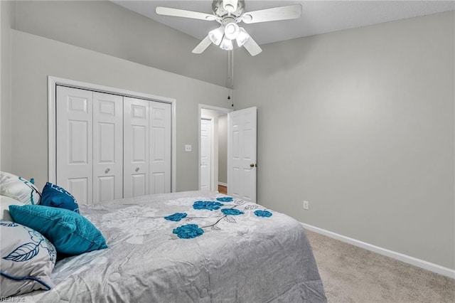 carpeted bedroom with lofted ceiling, a closet, and ceiling fan