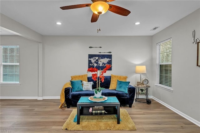 sitting room with wood-type flooring and ceiling fan