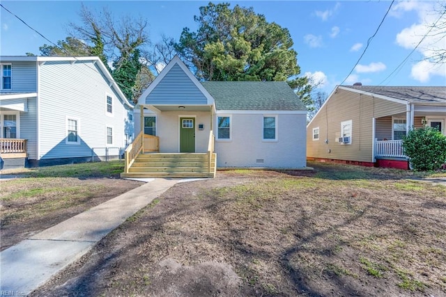 bungalow with a porch and cooling unit