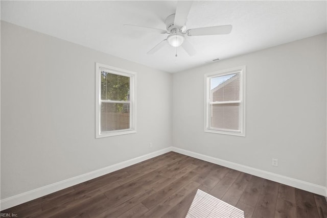 spare room featuring dark hardwood / wood-style floors and ceiling fan