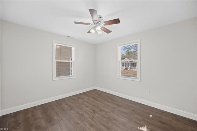 unfurnished room with ceiling fan and dark hardwood / wood-style flooring