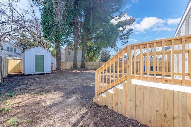 view of yard featuring a storage unit and a deck