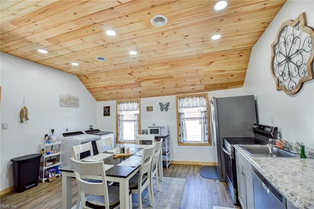 dining room featuring lofted ceiling, sink, wood ceiling, and light hardwood / wood-style flooring