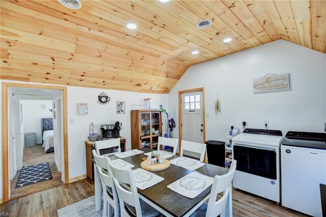 dining room with lofted ceiling, light wood-type flooring, wood ceiling, and independent washer and dryer