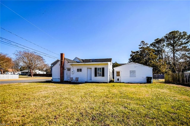 rear view of house with a yard