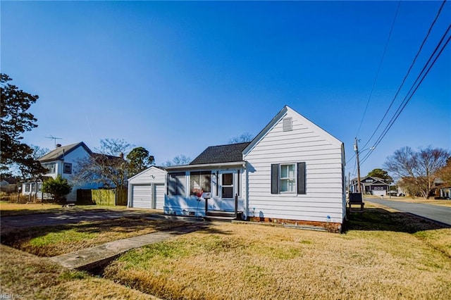 bungalow with a garage and a front yard