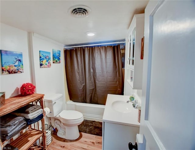 full bathroom with shower / tub combo with curtain, vanity, hardwood / wood-style flooring, and toilet