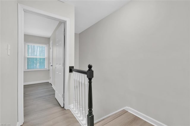 corridor with light hardwood / wood-style flooring