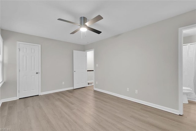 unfurnished bedroom with ensuite bathroom, ceiling fan, and light hardwood / wood-style flooring