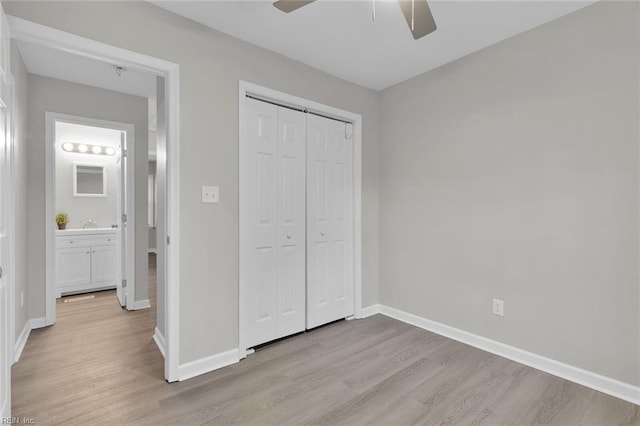 unfurnished bedroom with light hardwood / wood-style floors, a closet, and ceiling fan