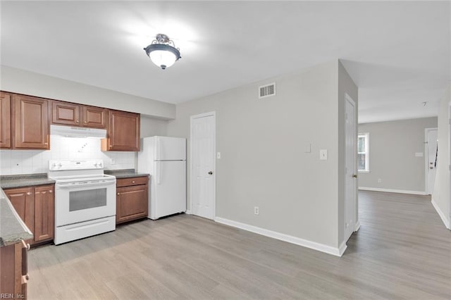 kitchen featuring white appliances, decorative backsplash, and light hardwood / wood-style flooring