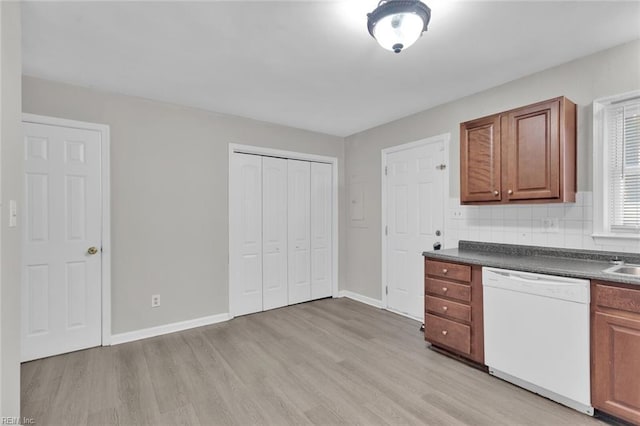 kitchen with tasteful backsplash, dishwasher, and light wood-type flooring