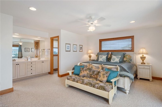 bedroom with multiple windows, ensuite bathroom, and ceiling fan