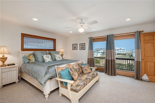 carpeted bedroom featuring multiple windows, access to outside, and ceiling fan