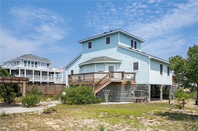 back of house with a deck and central air condition unit