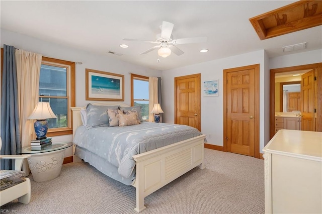 carpeted bedroom with multiple closets and ceiling fan