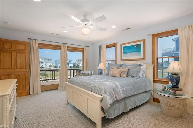 bedroom featuring access to outside, light colored carpet, and ceiling fan