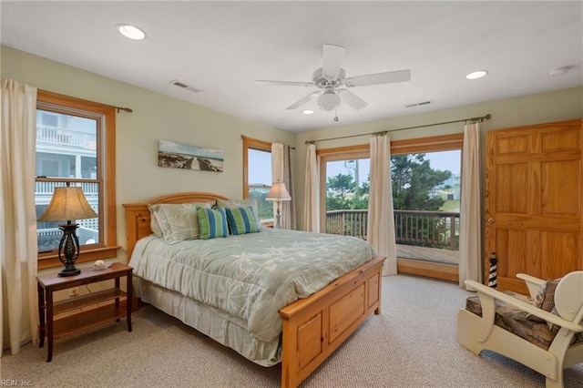 carpeted bedroom with ceiling fan and access to exterior