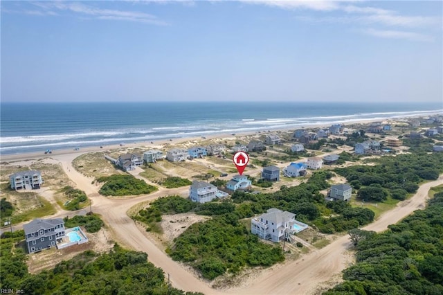 birds eye view of property with a beach view and a water view