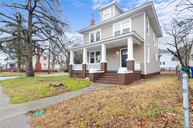 view of front facade with a front lawn and covered porch