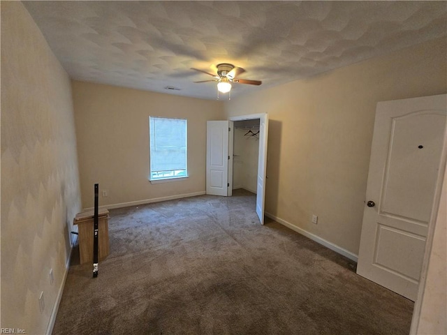 carpeted empty room with ceiling fan