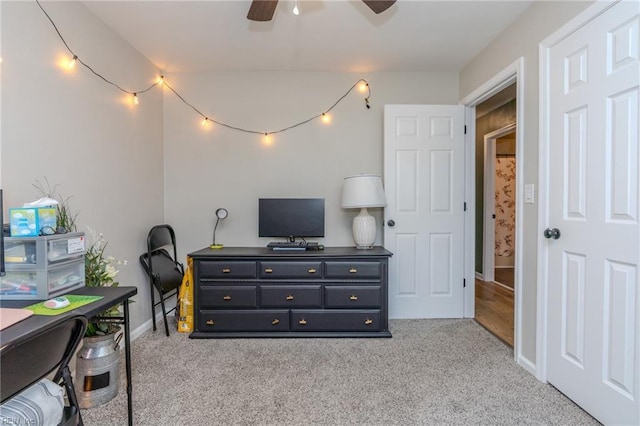 carpeted home office with ceiling fan