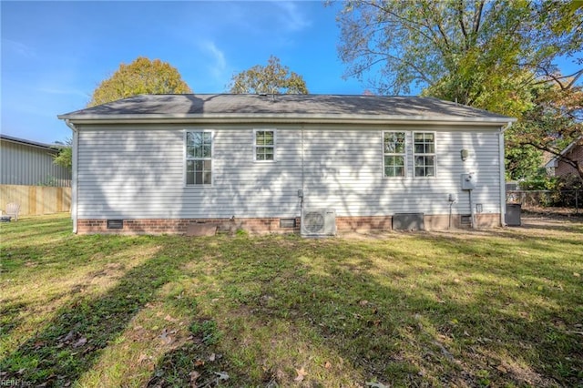 rear view of property with a yard