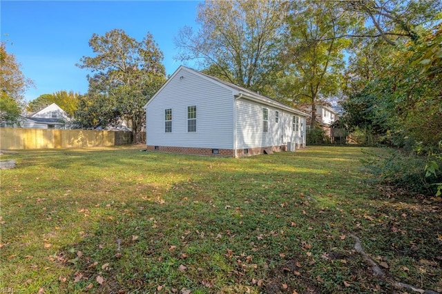 view of side of property with a lawn