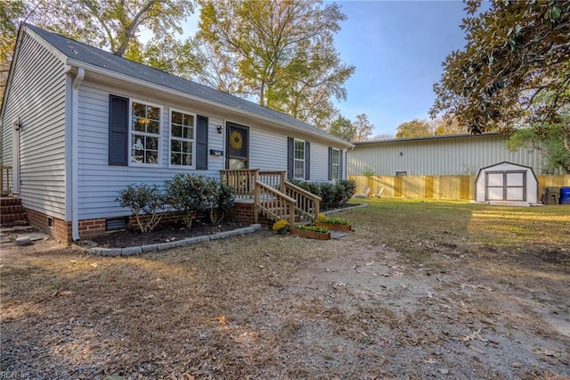 view of front of property with a storage shed