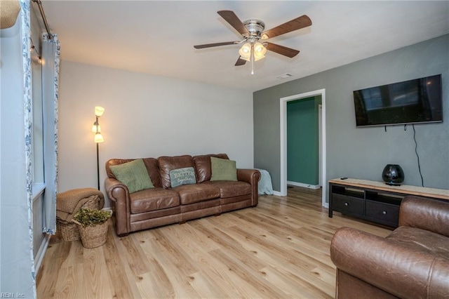 living room featuring ceiling fan and light hardwood / wood-style flooring