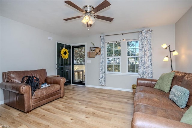 living room with ceiling fan and light hardwood / wood-style floors