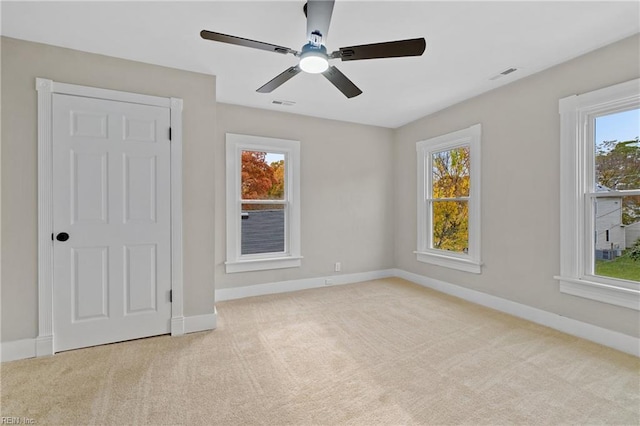 carpeted empty room featuring ceiling fan