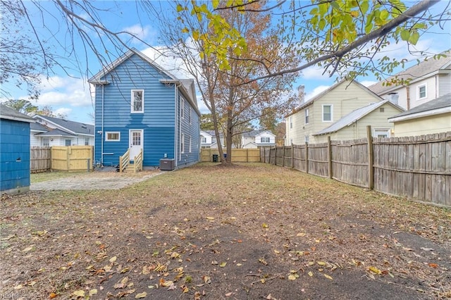 rear view of house with central AC