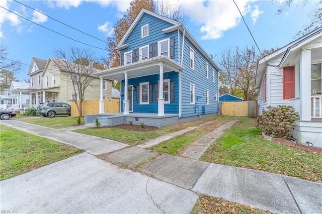 view of front of house with covered porch and a front yard