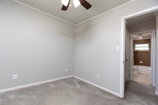 carpeted spare room with crown molding and ceiling fan