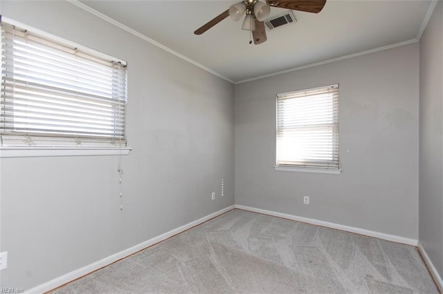 carpeted empty room featuring crown molding and ceiling fan