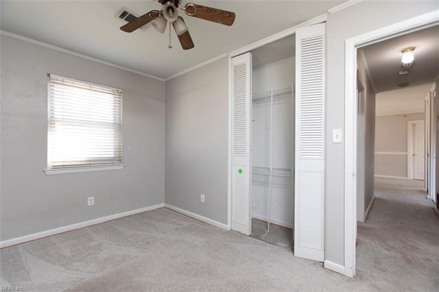 unfurnished bedroom with light carpet, crown molding, a closet, and ceiling fan