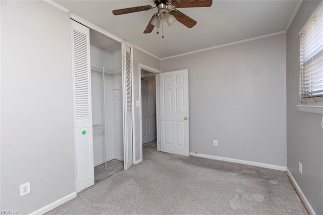 unfurnished bedroom with ceiling fan, a closet, ornamental molding, and light carpet