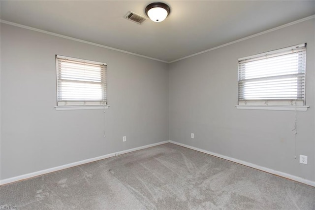 carpeted empty room with crown molding and plenty of natural light