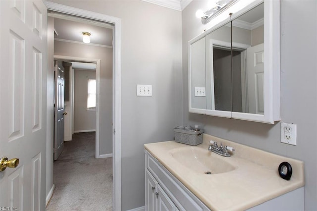 bathroom with crown molding and vanity