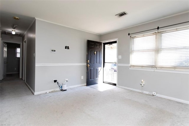 empty room with crown molding and light carpet