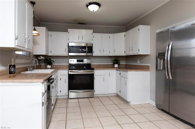 kitchen with white cabinetry, stainless steel appliances, crown molding, and sink