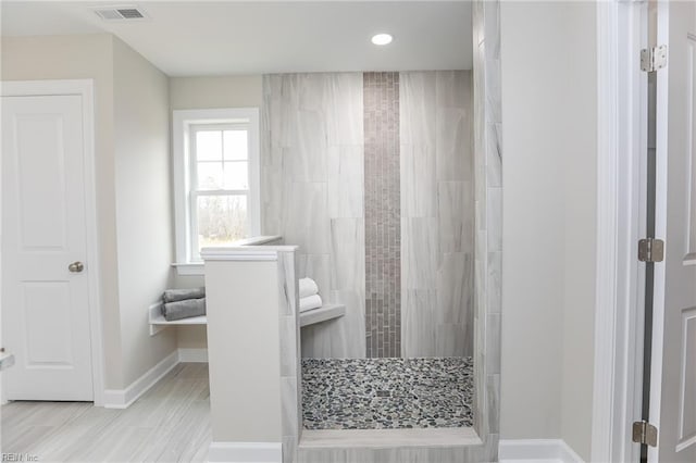 bathroom featuring tiled shower