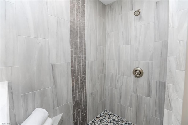 bathroom with a tile shower