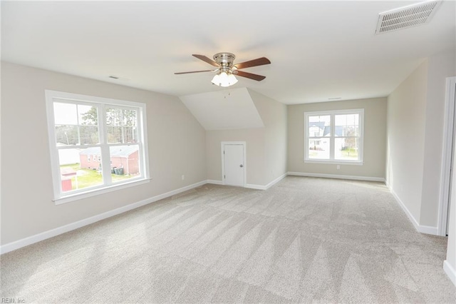 bonus room featuring lofted ceiling, light carpet, and ceiling fan